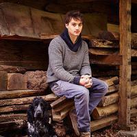 Ted Jefferis of TedWood and four legged friend sitting inteh woodshed