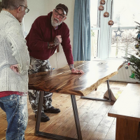 Handmade in Brighton waney edge dining table with butterfly joints bespoke metal trestle legs